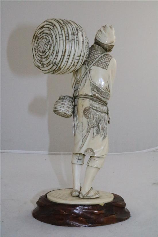 A large Japanese ivory figure of a fisherman, Meiji period, 25.5cm, wood stand